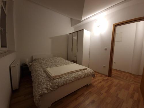 małą sypialnię z łóżkiem i szafą w obiekcie Apartman Sesvete w mieście Sesvete