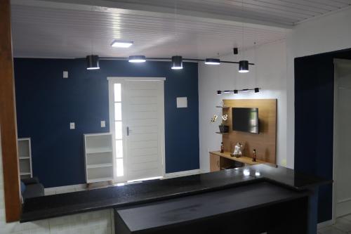 a bathroom with a sink and a mirror at Casa de Temporada em Gramado in Gramado