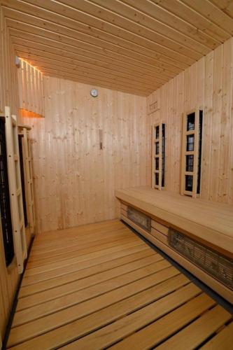 an empty room with wooden flooring in a wooden house at Miód Lawenda in Biardy