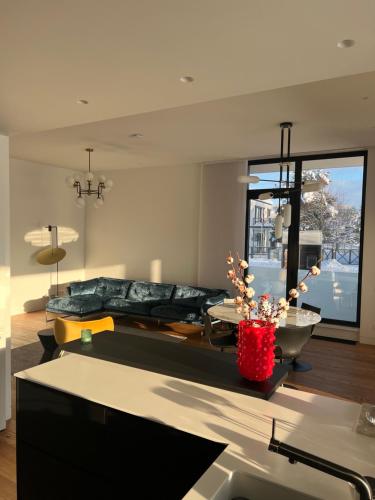 a living room with a bed and a large window at Mezapark Design Apartments in Rīga