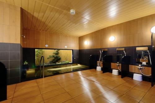 a bathroom with sinks and a swimming pool in it at Hotel Route-inn Ebina Ekimae in Ebina