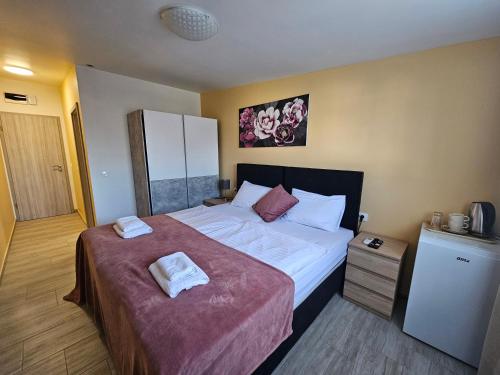 a bedroom with a large bed with two towels on it at Royal Apartments & Rooms in Zagreb