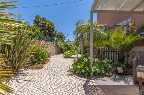 a patio with plants and a brick walkway at Villa Rosa in Lagos