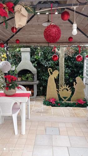 a patio with christmas decorations and a table and a fireplace at Trullo Di Tagaro in Locorotondo