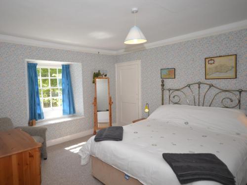 a bedroom with a large bed and a window at 4 Bed in Hartland HACOT in Hartland