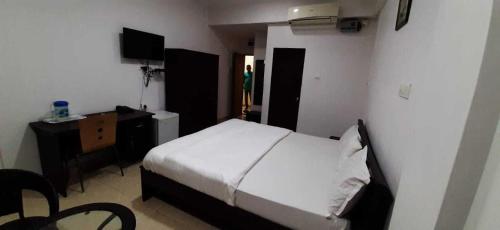 Ένα ή περισσότερα κρεβάτια σε δωμάτιο στο OYO Konkan House