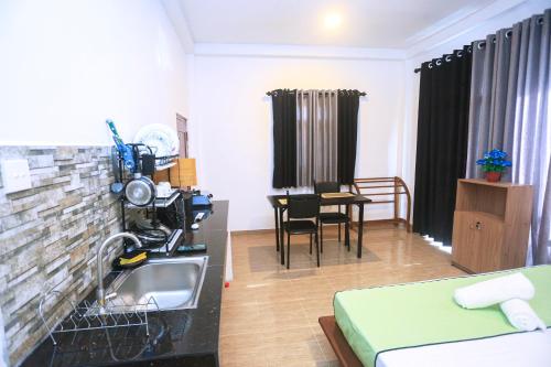 a kitchen and living room with a sink in a room at Villa Greenline in Ahangama