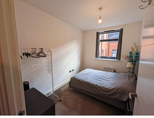 a bedroom with a bed and a window at Free Parking Luxury 1 Bed,BHX,NEC,RESORTS WORLD. in Birmingham