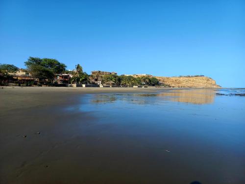 a view of a beach with trees and the water at Casa Entre Rocas y Veleros in Los Órganos