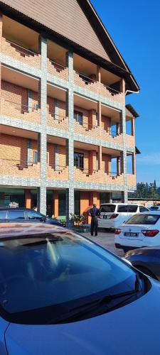 a car parked in a parking lot in front of a building at Tekoma Resort Cameron Highlands in Tanah Rata