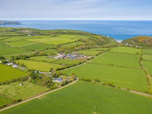 an aerial view of green fields and the ocean at Great Tree House in Llangranog