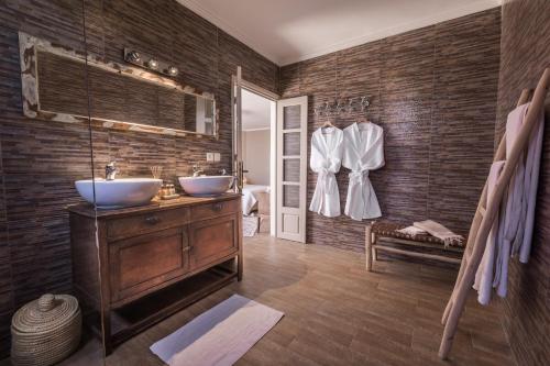 a bathroom with two sinks and brick walls at Villa Beldi in Essaouira