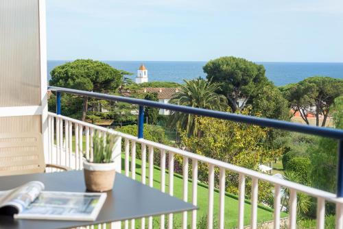 a balcony with a table and a view of the ocean at Hotel Alga in Calella de Palafrugell