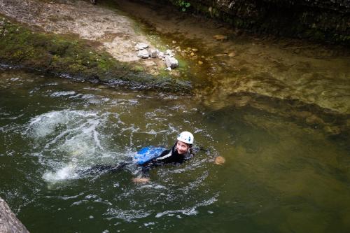 a man in the water in a river at Almdorf Almlust in Flachau