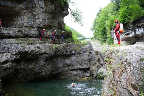 a group of people standing on rocks in a river at Almdorf Almlust in Flachau