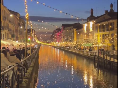 a view of a canal with lights and buildings at Sun shine in Cesano Boscone