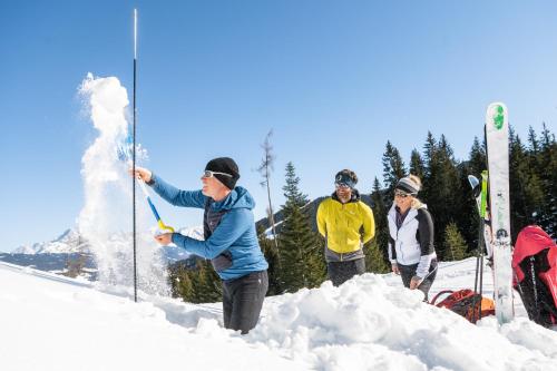 a group of people standing in the snow at Almdorf Almlust in Flachau