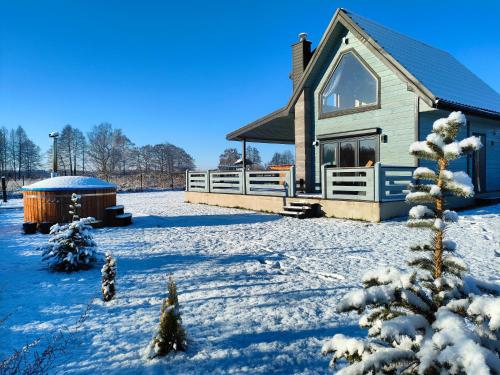 a house in the snow with a hot tub at Kamyczek in Stare Juchy