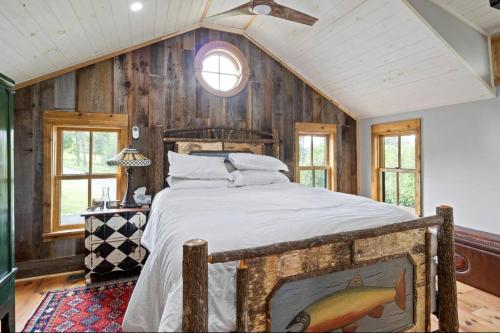 a bedroom with a large bed in a room with wooden walls at Cozy Two Bedroom Home On Canandaigua Lake in Rushville