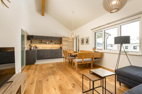 a living room with a table and a couch at The Nest in Aich by Schladming-Appartements in Aich