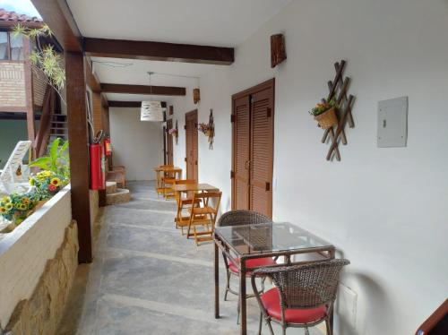 a dining room with chairs and a table and tables at Pousada Kyrios in Maresias