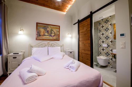 a bedroom with a white bed with towels on it at Agios Germanos in Agios Germanos