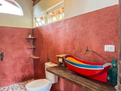 a bathroom with a colorful bath tub on a counter at Chalé com vista para o mar in Ilhabela
