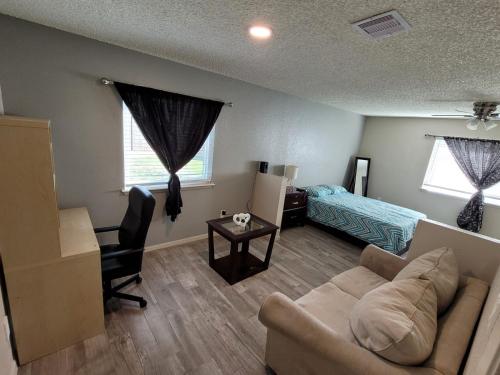 a living room with a couch and a bed at Big room with a private bathroom in Houston