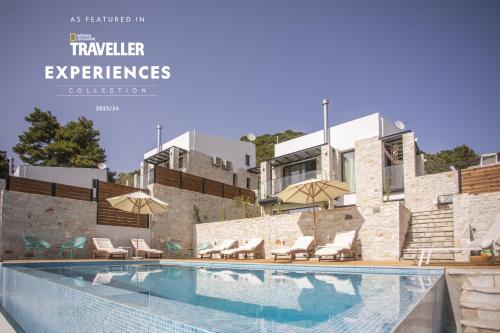 a swimming pool with chairs and umbrellas next to a building at Damari Luxury Retreat Villas Skiathos in Skiathos Town