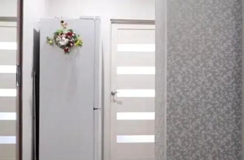 a door with a wreath on it next to a mirror at VIP apart 680 in Tbilisi City