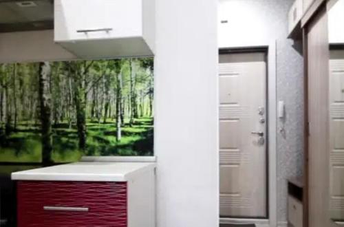a bathroom with a painting of a forest at VIP apart 680 in Tbilisi City