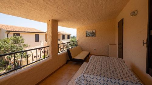 a room with a bed and a balcony at Appartamenti Agrustos in Budoni