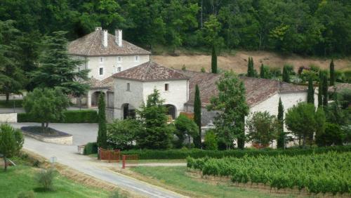 a large white house with a garden and trees at Château Lecusse - La Grande Roche - Hôtel, Spa, Boutique & Restaurant in Broze