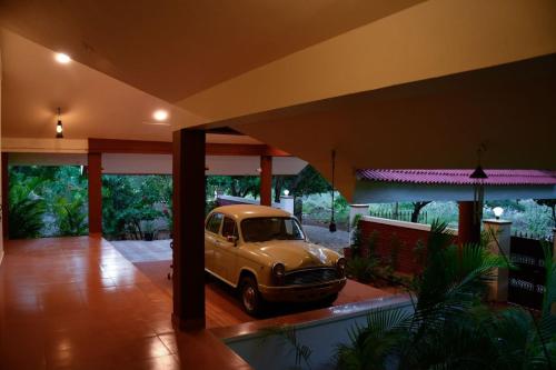 an old car parked inside of a house at Ashirwad homestay madurai...A Rustic Villa Amidst peacocks in Madurai