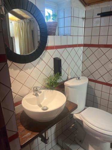 a bathroom with a toilet and a sink and a mirror at G.Home in Catania