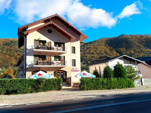 a building on the side of a road at Pensiunea Karina in Caciulata