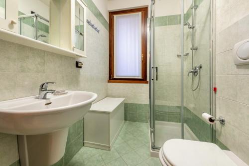 y baño con lavabo y ducha. en Rosa Flat - with Pool, en Polpenazze del Garda
