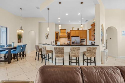a living room and kitchen with a couch and a table at Luxury Waterfront Direct Gulf access - Walk to Beach & Bikes - Villa Coral Mist - Cape Coral in Cape Coral