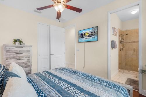 a bedroom with a bed and a ceiling fan at Luxury Waterfront Direct Gulf access - Walk to Beach & Bikes - Villa Coral Mist - Cape Coral in Cape Coral