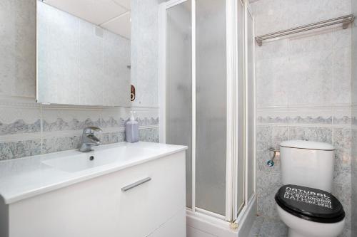 a bathroom with a toilet and a sink and a shower at Benalmarina in Benalmádena