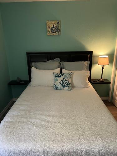 a large bed with two pillows on top of it at La Adventura Villa in Seminole