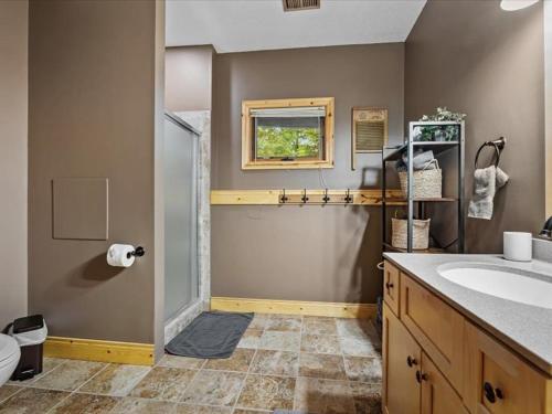 a bathroom with a sink and a toilet at The Loonstar Lodge On Rabbit Lake in Crosby