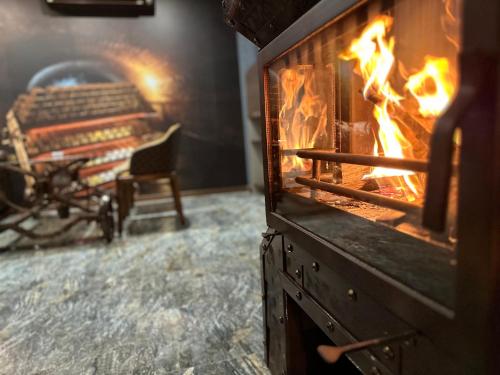 a fire oven in a room with a chair at HIDDEN BANK: Digger's Dream in Plovdiv