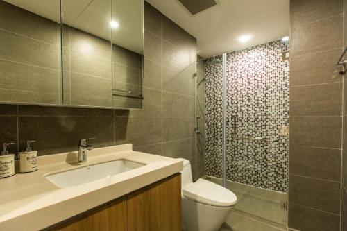 a bathroom with a sink and a toilet and a shower at Republic Apartment Nearby Airport Free Pool Gym in Ho Chi Minh City