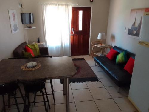 a living room with a couch and a table at Raiden's Home in Saldanha