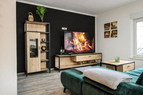 a living room with a flat screen tv on a wall at Chill Out Area, Sauna & Wirlpool, grandiose Aussicht, Smart TV, Netflix in Zell an der Mosel