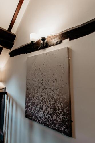 a painting hanging on a wall with a ceiling at Oak Farm Hotel in Cannock