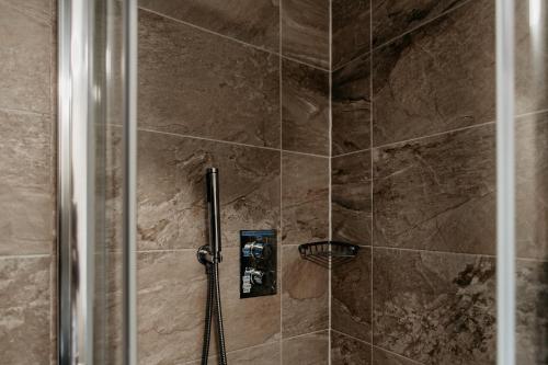 a bathroom with a shower with a glass door at Oak Farm Hotel in Cannock