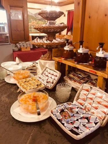 a buffet with many different types of food in trays at Hotel Sole del Baldo in Brentonico