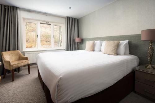 a bedroom with a large white bed and a window at Windermere Rooms at The Wateredge Inn in Ambleside